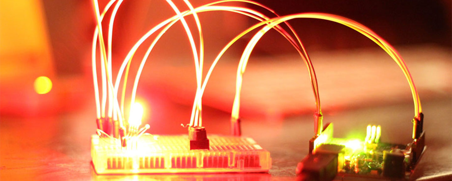Arduino microcontroller wired to a breadboard controlling an RGB LED
